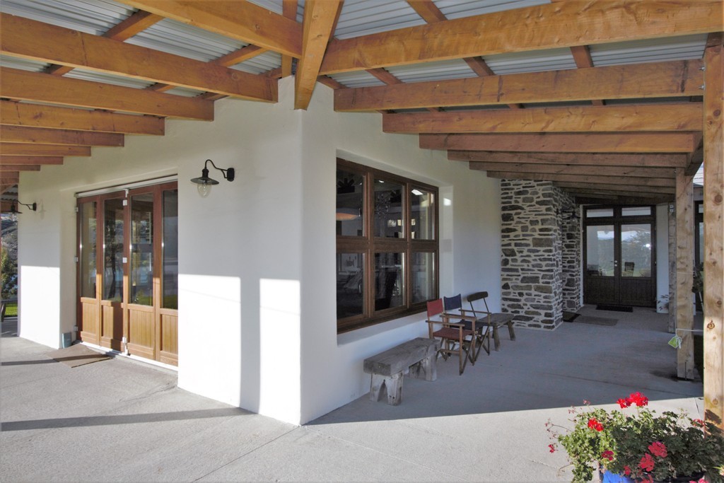 Macrocarpa veranda and Rockcote plaster with 68mm oak windows and doors