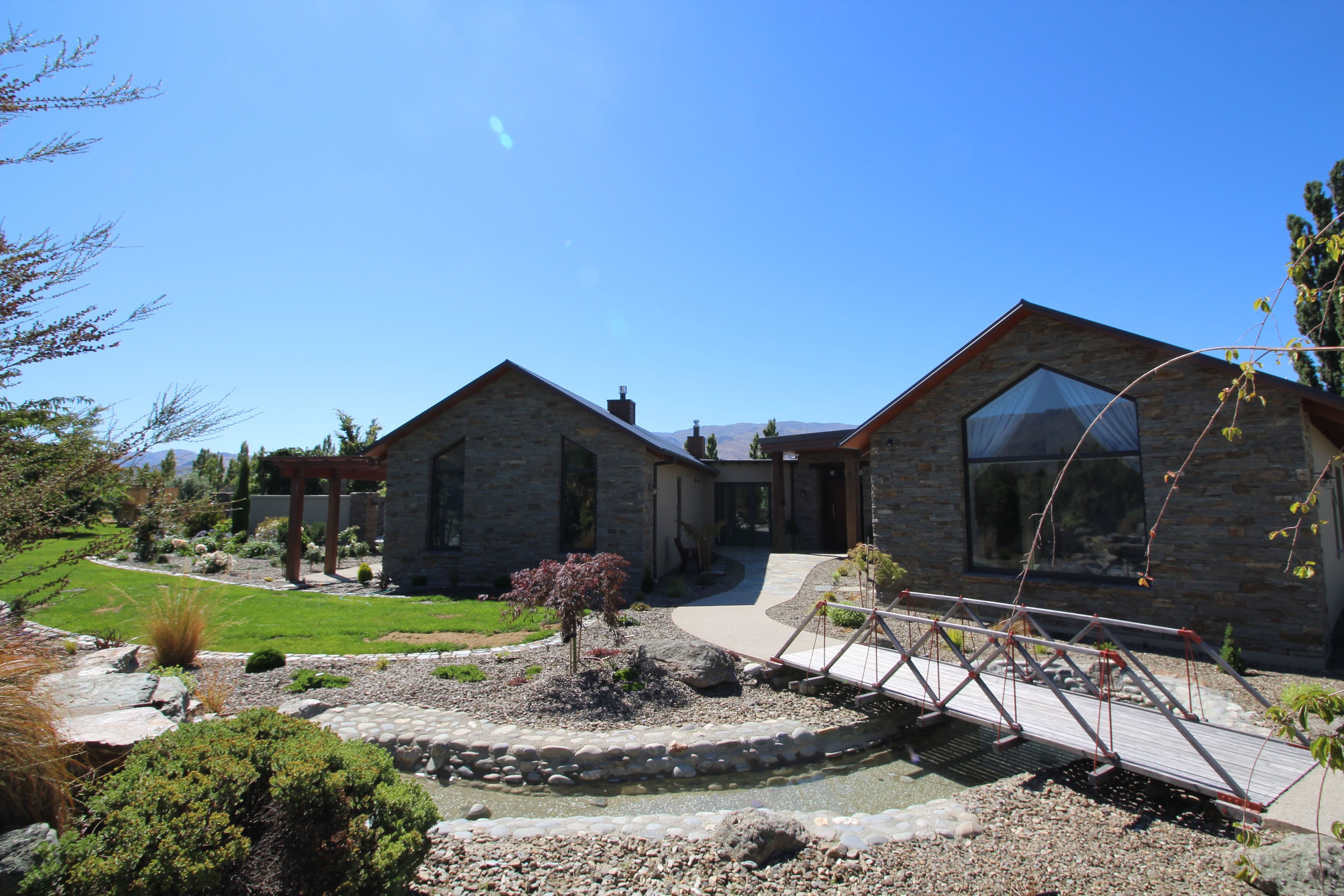 with a combination of styles this Schist clad home has various techniques of stone masonry around the home