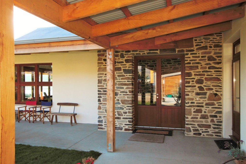 Stone entryway with Macrocarpa timber veranda