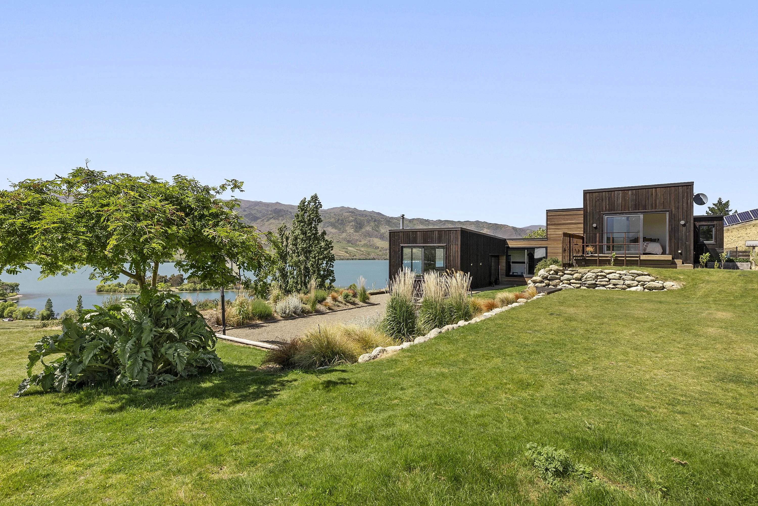 Overlooking Lowburn Harbor sits this stunning 5 bedroom home with 1 hectare of land